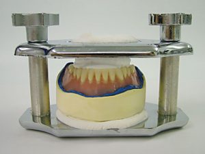 Pour and place denture in reline jig as usual for acrylic reline